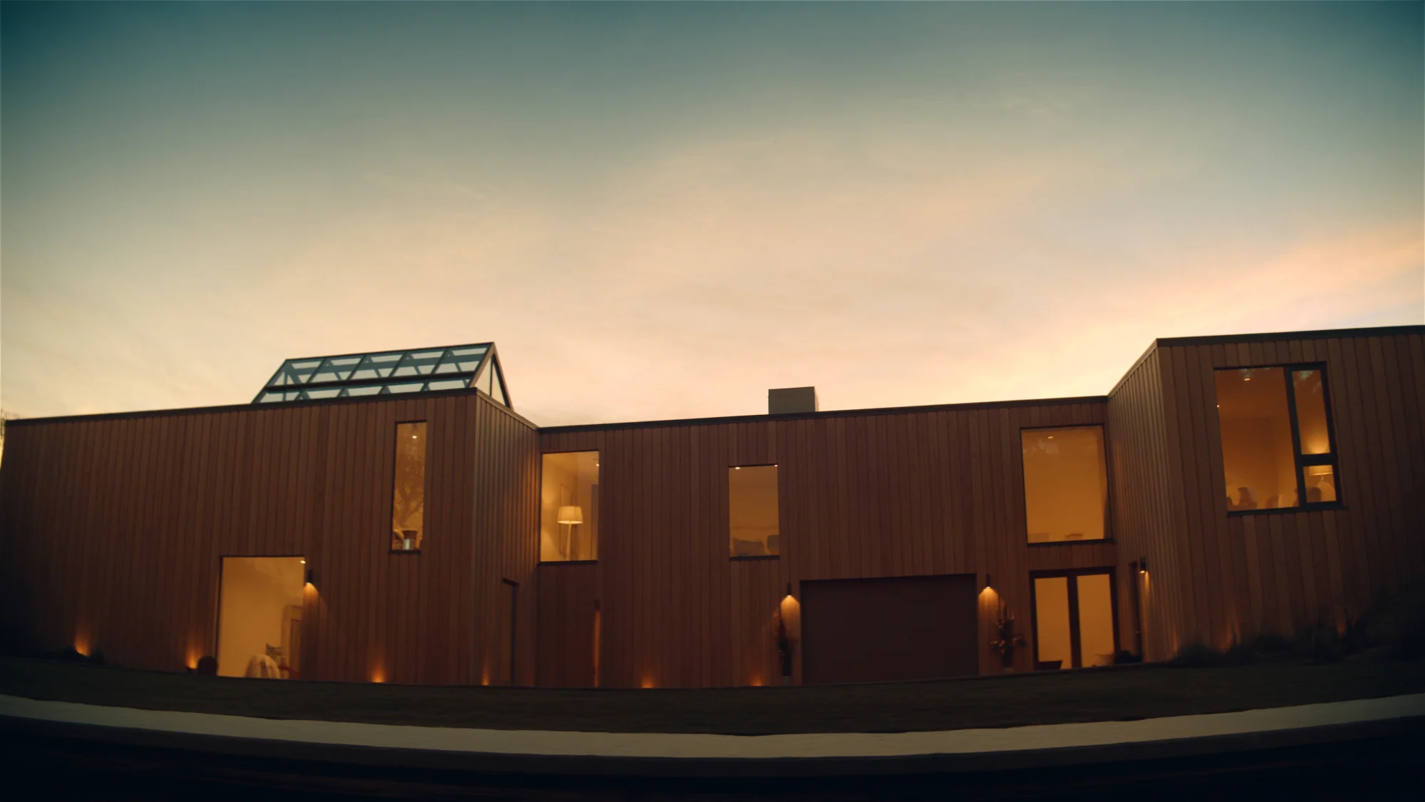 Moderne houten woning bij avondschemering met warme raamverlichting